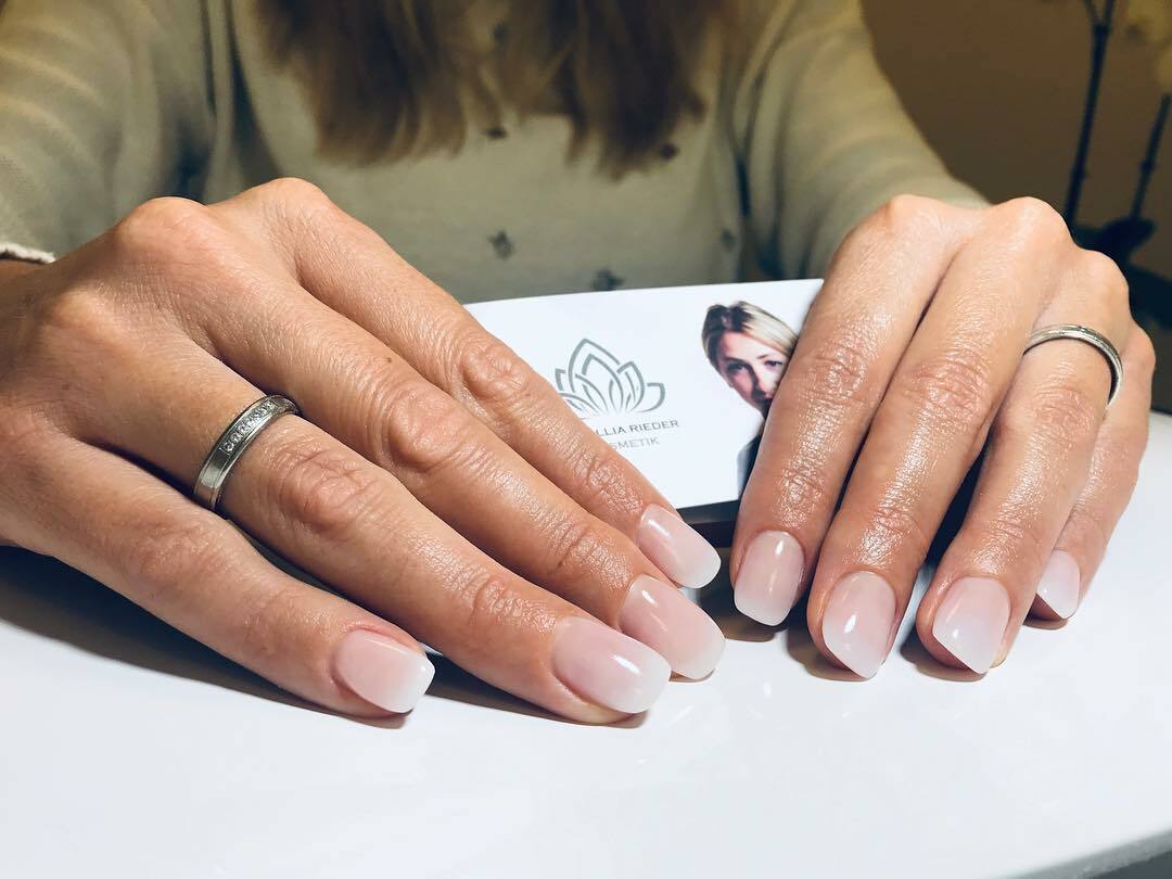 Foto von Händen einer Frau mit rosanan Fingernägeln